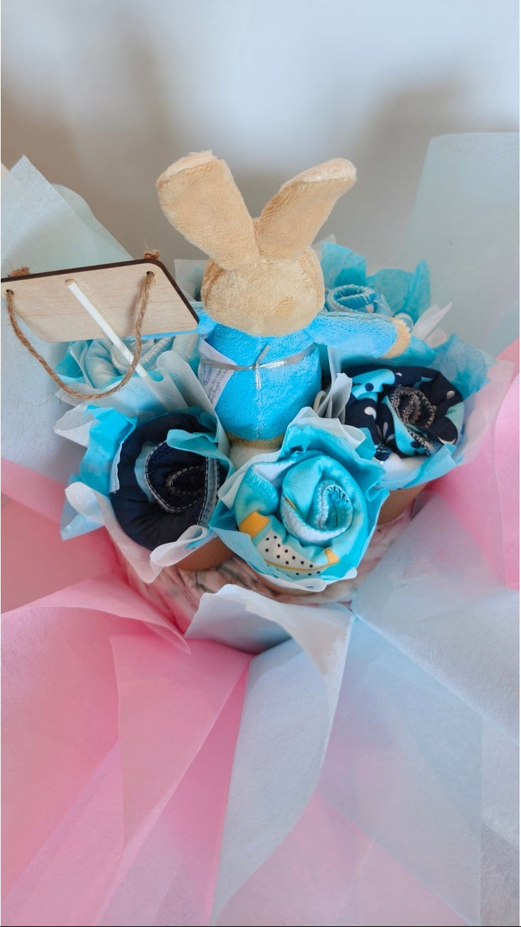 Back view of Peter Rabbit Little Explorer bouquet nappy cake baby gift set showing arrangement details, paper cones, and pastel paper wrapping.