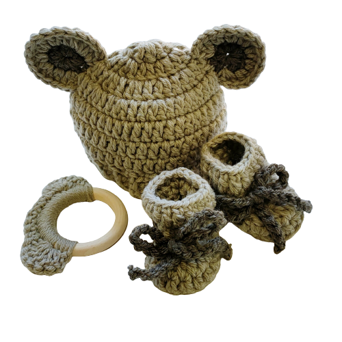 Handmade brown wool hat with ear details, a matching tether, and booties set against a white background.