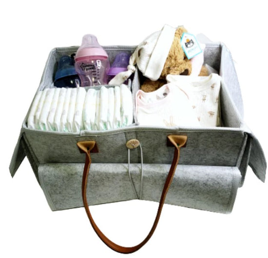 nappy cake packaging showing neatly wrapped baby gift with ribbons soft toys and clear wrap