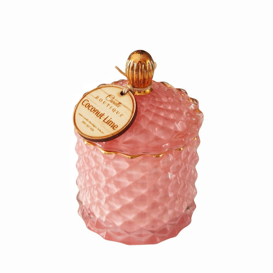 Royal pink Baby Geo glass candle jar in Coconut Lime scent by Candle Boutique, featuring a textured diamond pattern, gold-accented lid, and rustic wooden tag.