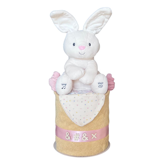 Bunny Baby Gift Nappy Cake featuring a musical plush bunny, towel, bandana bib premium baby essentials.