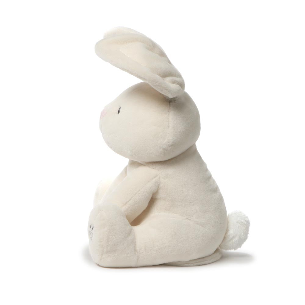 Left side view of GUND Flora Bunny animated plush with ear raised and fluffy tail
