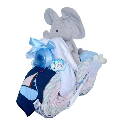Front angled view of the Elephant Motorbike Nappy Cake with plush elephant, baby bottle, bib and nappies.