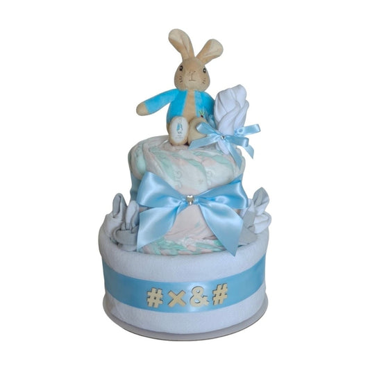 Peter Rabbit Classic New Parents 2-tier baby boy nappy cake gift set featuring a plush bunny toy, rolled nappies, and light blue ribbon trim.