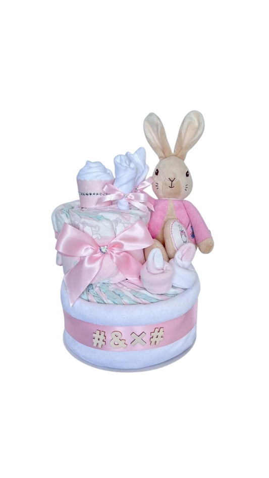 2-Tier Bunny sisnature Nappy Cake featuring a plush bunny, baby socks, cupcake, satin bow premium baby girl gift essentials.