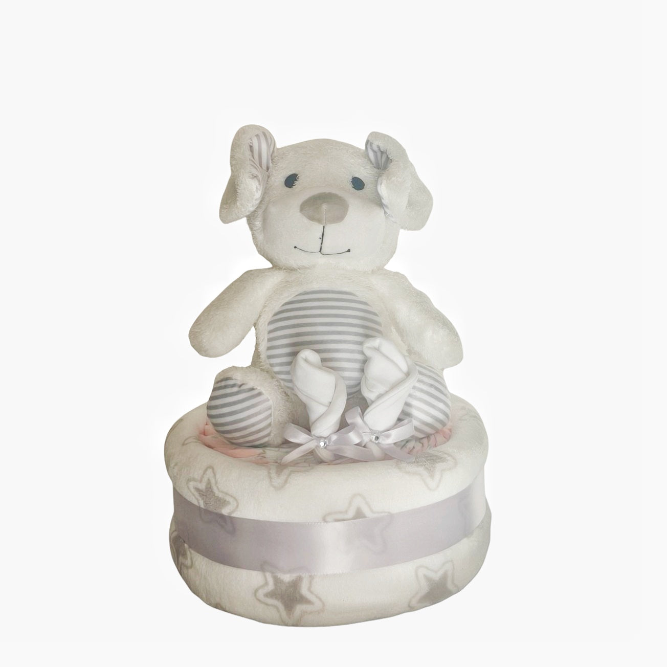 Unisex puppy dog baby nappy cake gift set, including a striped plush puppy toy, baby mittens, and a star-patterned receiving blanket wrapped in a grey ribbon.
