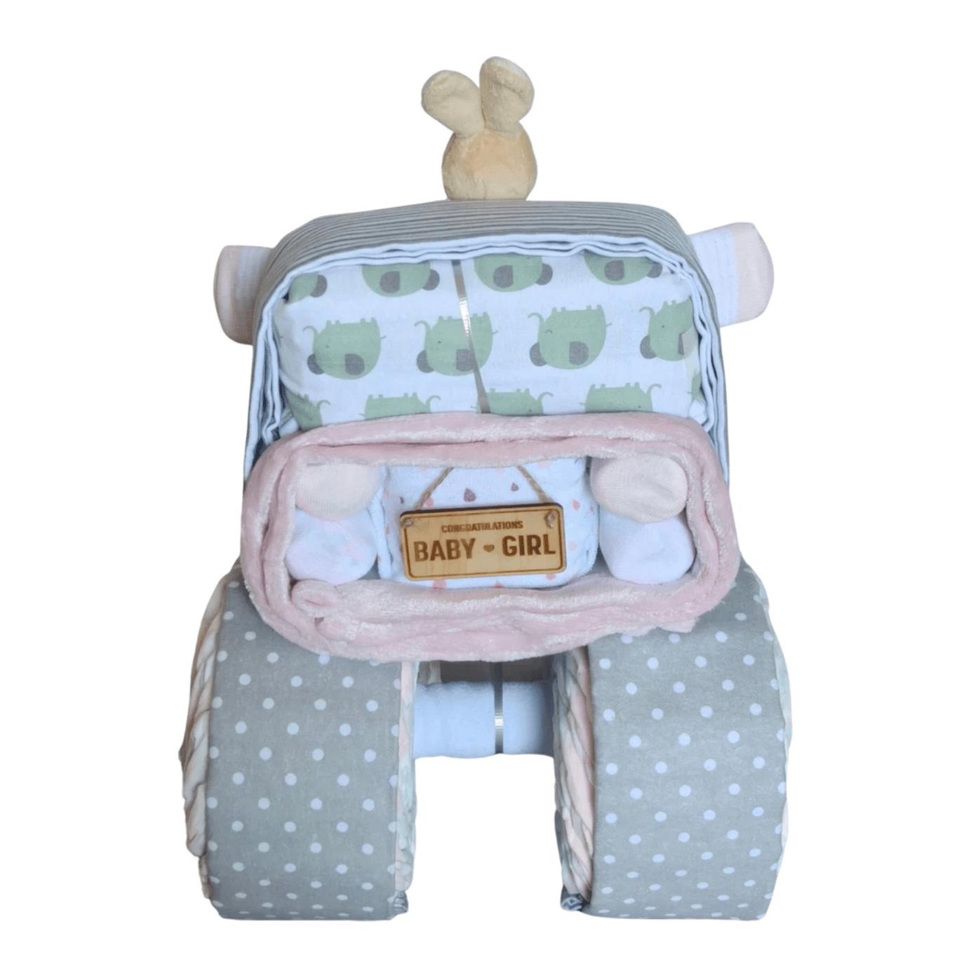 Back view of a baby girl truck nappy cake gift set showing grey polka-dot wheels, a green elephant print wrap, and a wooden Baby Girl sign.