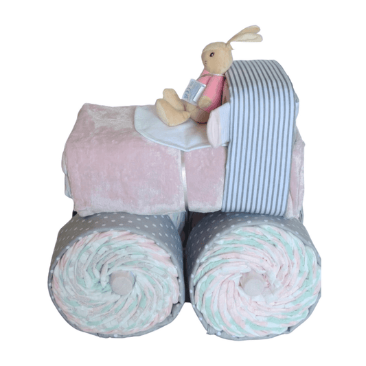 Side profile of a pink and grey truck nappy cake for baby girls featuring a Bunny plush toy sitting in the cab.