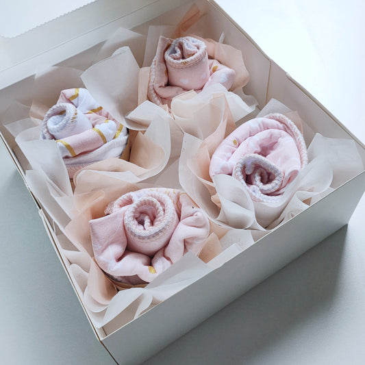 beautiful pink lady bib cupcakes gift box baby shower present styled with bibs and cupcake design