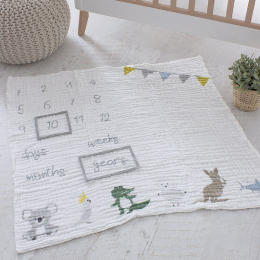 Aussie Animals baby milestone muslin blanket flat lay showing age tracking numbers and Australian animal prints including a koala, crocodile, and kangaroo.