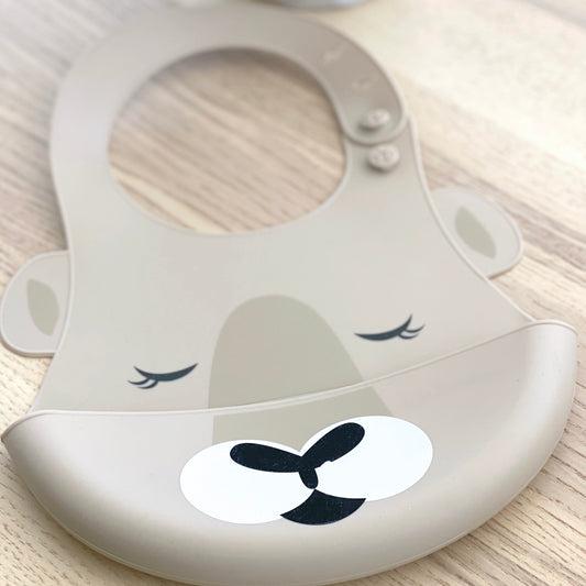 Bubba Blue Australia silicone baby bib with kangaroo design, adjustable neck strap and crumb catcher in taupe.