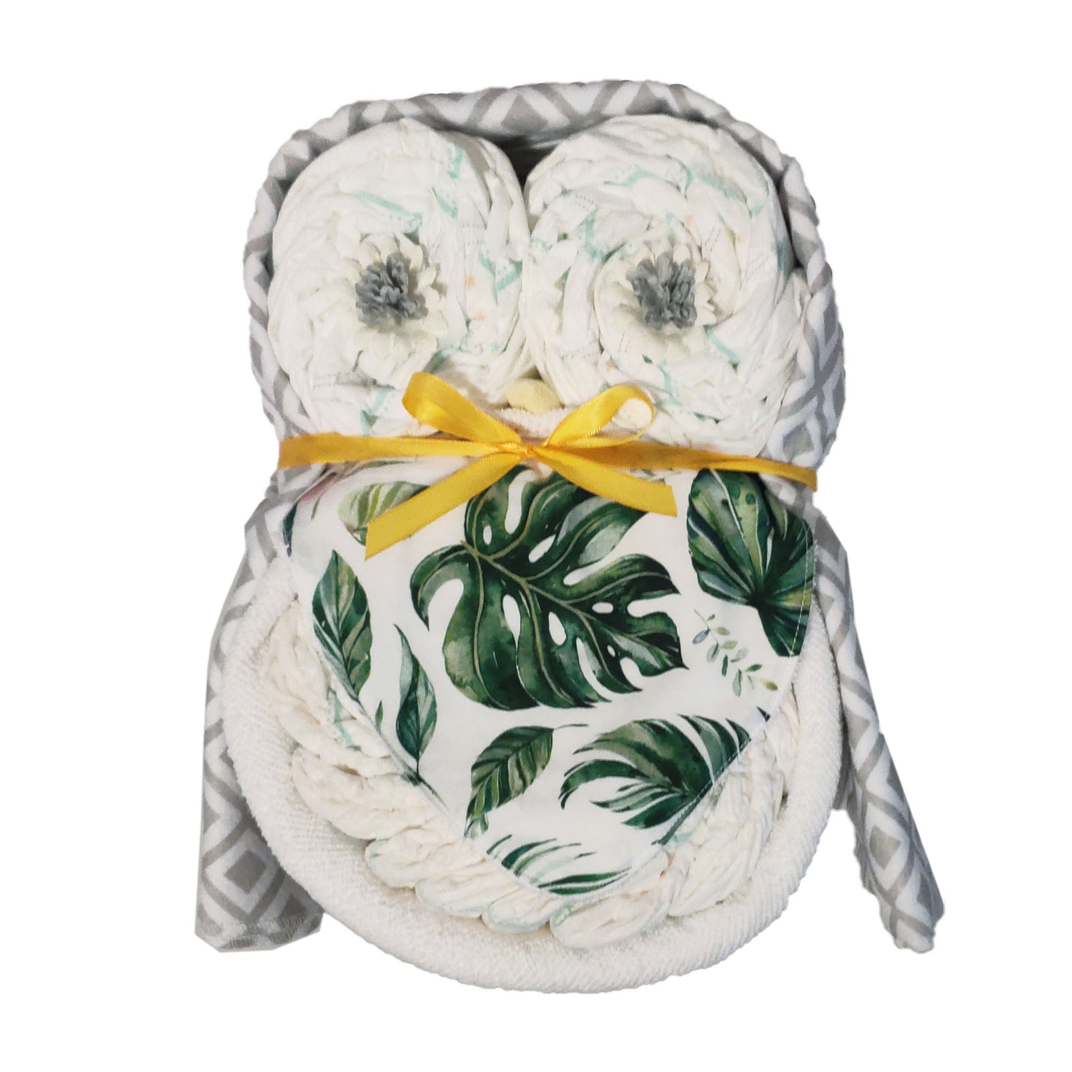 Green tropical leaf owl nappy cake baby shower gift set featuring a print bib, rolled infant nappies, and a grey geometric receiving blanket.