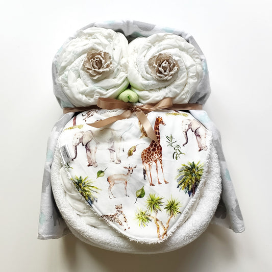 Woodie unisex baby owl nappy cake gift set featuring rolled nappies, Nappy Terry Towel, baby bib, receiving blanket, and a tan ribbon bow.